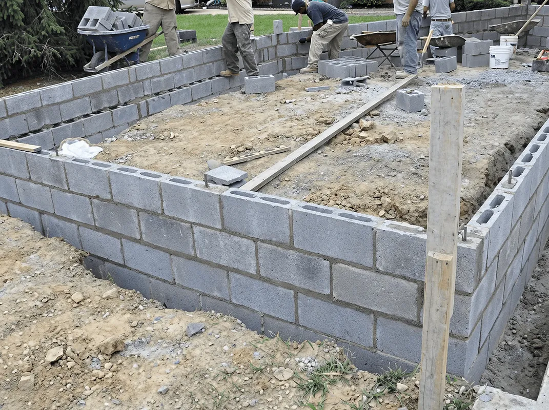 Professionals building a foundation with blocks in Worcester, MA